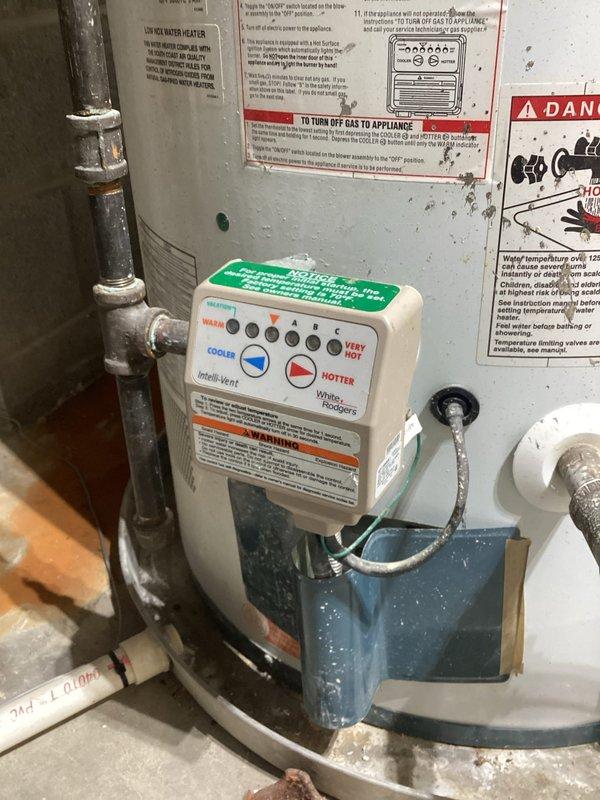 Responded to service call for tanked water heater with no hot water delivery to one side of the house. Upon arrival, inspected the White-Rodgers electronic control unit mounted on the water heater and observed status indicator lights showing green on cold side and yellow lights on heat side, indicating a control system malfunction. Diagnosed faulty temperature controller preventing proper heating element operation. Evaluated the complete plumbing configuration including copper supply lines, circulation pump assembly, and associated electrical connections. Verified proper gas supply and venting system integrity. Reset controller and tested heating elements to restore hot water distribution throughout the residence. Confirmed all safety systems operational and water temperature settings within manufacturer specifications.