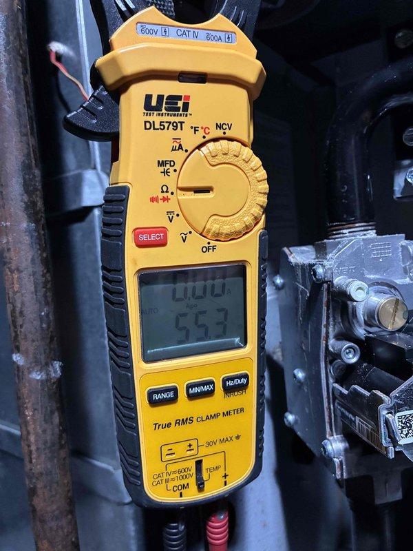 Completed scheduled heating maintenance visit on residential furnace system. Performed comprehensive inspection of burner assembly, confirmed proper ignition and flame characteristics with all burners operating efficiently and producing consistent blue flames. Verified electrical performance using digital clamp meter, measuring amperage draw and system voltage to ensure components are functioning within manufacturer specifications at 0.00A standby and 55.3°F temperature readings. Inspected burner chamber, heat exchanger access area, and all visible wiring connections for signs of wear or deterioration. System operating properly with no deficiencies noted at time of service.