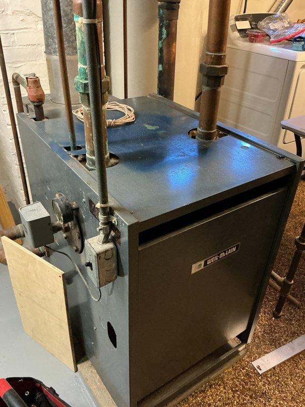 Completed comprehensive heating tune-up and safety inspection on Weil-McLain boiler system for new homeowner. Performed full operational assessment including burner inspection, heat exchanger examination, flue gas analysis, and pressure testing of all piping connections. Verified proper operation of pressure relief valve, circulator pumps, and zone controls. Inspected all copper supply and return piping for leaks and corrosion, noting existing patina on older copper lines consistent with system age. Tested ignition system, flame sensor, and all safety controls to ensure proper shutdown sequences. Confirmed adequate combustion air supply and verified proper venting. System found to be operating within manufacturer specifications with no immediate safety concerns or required repairs at time of inspection. Completed comprehensive heating tune-up and safety inspection on Weil-McLain boiler system for new homeowner. Performed full operational assessment including burner inspection, heat exchanger examination, flue gas analysis, and pressure testing of all piping connections. Verified proper operation of pressure relief valve, circulator pumps, and zone controls. Inspected all copper supply and return piping for leaks and corrosion, noting existing patina on older copper lines consistent with system age. Tested ignition system, flame sensor, and all safety controls to ensure proper shutdown sequences. Confirmed adequate combustion air supply and verified proper venting. System found to be operating within manufacturer specifications with no immediate safety concerns or required repairs at time of inspection.