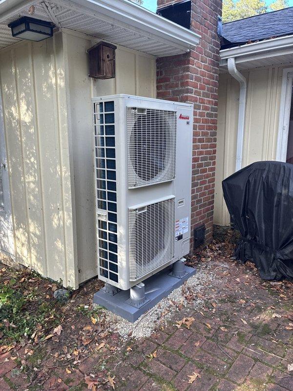 Installed a new Amana heat pump condensing unit on a level composite pad as part of an oil-to-heat-pump system conversion, with refrigerant lines routed and insulated to the outdoor unit. Mounted and wired a DiversiTech electrical disconnect with flexible conduit to the condenser, with dedicated circuits supplied by the electrical contractor. The installed unit is clean and undamaged, with no signs of frost, rust, or leaks.