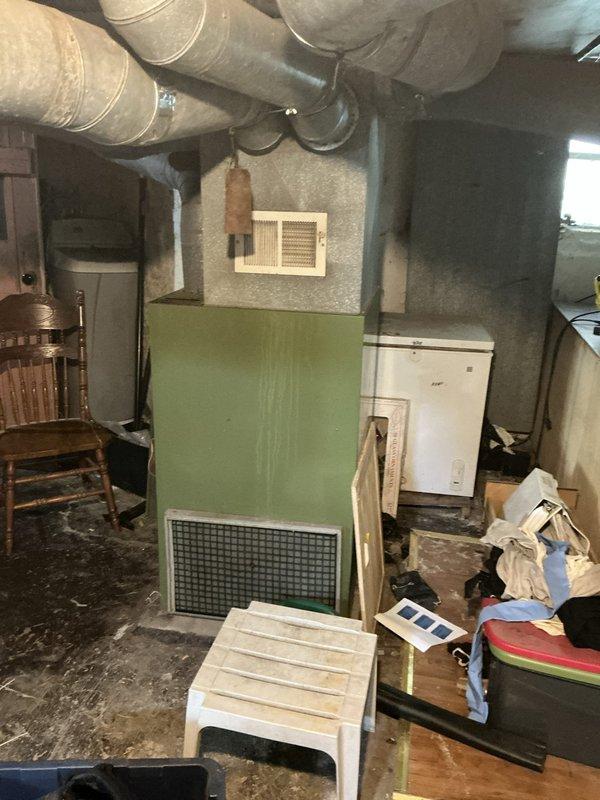 Performed a replacement estimate on a 40-year-old furnace after a diagnostic confirmed a cracked heat exchanger, rendering the unit unsafe for continued operation. Inspected the basement installation, noting easy access to the unit, plenum, and ductwork, and reviewed the adjacent electrical panel and surrounding conditions for installation planning. Presented replacement furnace options to the customer. Performed a replacement estimate on a 40-year-old furnace after a diagnostic confirmed a cracked heat exchanger, rendering the unit unsafe for continued operation. Inspected the basement installation, noting easy access to the unit, plenum, and ductwork, and reviewed the adjacent electrical panel and surrounding conditions for installation planning. Presented replacement furnace options to the customer.