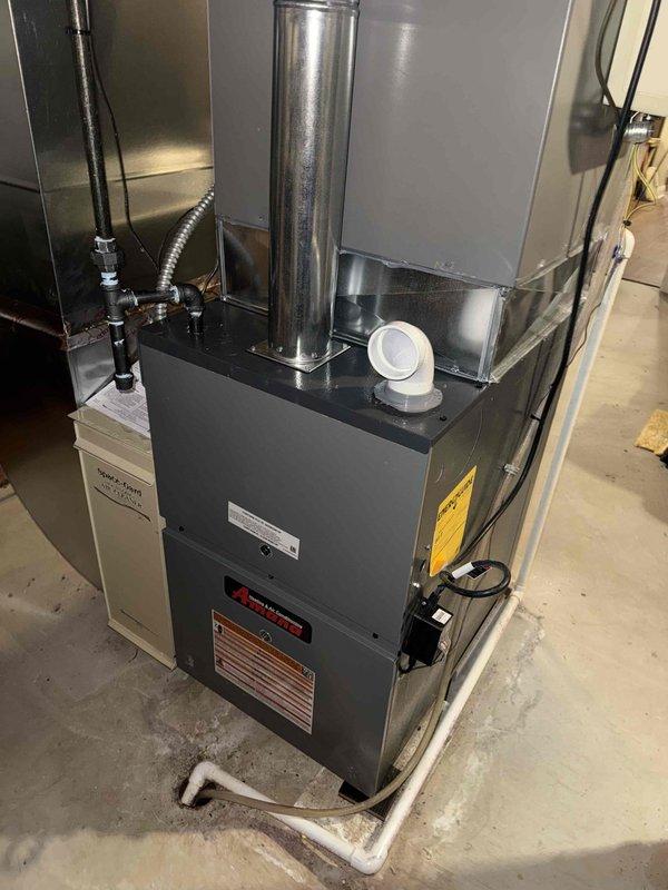 Installed a new 80% AFUE Amana gas furnace with a flue liner, connecting the gas supply line with a black iron pipe and flexible connector, and completing the electrical disconnect and condensate drain routing to the floor drain. Reconnected to the existing supply ductwork and Space-Gard air cleaner, then verified proper venting, safe combustion, and system operation at startup. Installed a new 80% AFUE Amana gas furnace with a flue liner, connecting the gas supply line with a black iron pipe and flexible connector, and completing the electrical disconnect and condensate drain routing to the floor drain. Reconnected to the existing supply ductwork and Space-Gard air cleaner, then verified proper venting, safe combustion, and system operation at startup.