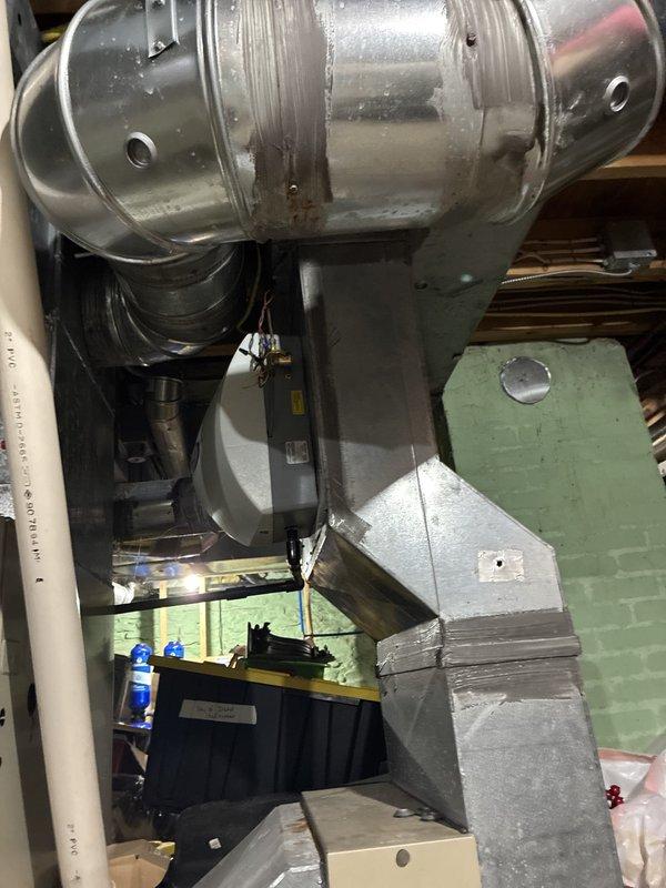 Performed an on-site evaluation for replacement of an existing 33-year-old furnace, assessing the unit, the connected galvanized supply ductwork, and the exterior electrical service components. Documented the condition of the ductwork, including taped and mastic-sealed seams, a patched section, and minor surface corrosion, along with the exterior electrical enclosure and outlet locations, to determine the scope for a replacement installation. Performed an on-site evaluation for replacement of an existing 33-year-old furnace, assessing the unit, the connected galvanized supply ductwork, and the exterior electrical service components. Documented the condition of the ductwork, including taped and mastic-sealed seams, a patched section, and minor surface corrosion, along with the exterior electrical enclosure and outlet locations, to determine the scope for a replacement installation.