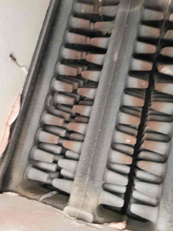 Performed scheduled boiler maintenance, including inspection of the cast iron heat exchanger sections, which showed heavy dust and soot accumulation with surface corrosion on the fin edges. Opened the burner compartment and inspected the gas valve assembly, manifold, and burner tubes, cleaning soot and residue from the burners and orifices with a wire brush and verifying wiring connections at the gas valve were secure. Noted frayed cabinet insulation for monitoring and recommended follow-up on the corrosion at the heat exchanger. Performed scheduled boiler maintenance, including inspection of the cast iron heat exchanger sections, which showed heavy dust and soot accumulation with surface corrosion on the fin edges. Opened the burner compartment and inspected the gas valve assembly, manifold, and burner tubes, cleaning soot and residue from the burners and orifices with a wire brush and verifying wiring connections at the gas valve were secure. Noted frayed cabinet insulation for monitoring and recommended follow-up on the corrosion at the heat exchanger.