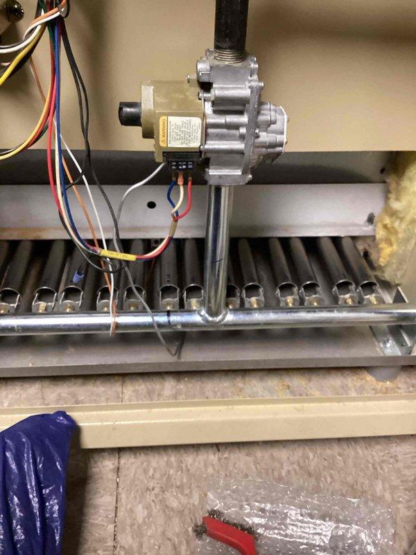 Performed scheduled boiler maintenance, including inspection of the cast iron heat exchanger sections, which showed heavy dust and soot accumulation with surface corrosion on the fin edges. Opened the burner compartment and inspected the gas valve assembly, manifold, and burner tubes, cleaning soot and residue from the burners and orifices with a wire brush and verifying wiring connections at the gas valve were secure. Noted frayed cabinet insulation for monitoring and recommended follow-up on the corrosion at the heat exchanger. Performed scheduled boiler maintenance, including inspection of the cast iron heat exchanger sections, which showed heavy dust and soot accumulation with surface corrosion on the fin edges. Opened the burner compartment and inspected the gas valve assembly, manifold, and burner tubes, cleaning soot and residue from the burners and orifices with a wire brush and verifying wiring connections at the gas valve were secure. Noted frayed cabinet insulation for monitoring and recommended follow-up on the corrosion at the heat exchanger.