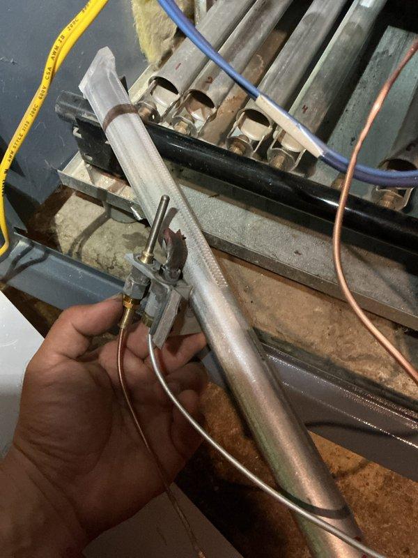 Performed annual tune-up on a Weil-McLain hydronic boiler (approx. 28 years old), including removal of the burner assembly for inspection and cleaning. Cleaned the burner tubes and pilot assembly of dust, rust, and scale buildup, then reinstalled and verified proper ignition and flame characteristics. Noted light scorching and age-related discoloration on components, with the unit operating normally at completion. Performed annual tune-up on a Weil-McLain hydronic boiler (approx. 28 years old), including removal of the burner assembly for inspection and cleaning. Cleaned the burner tubes and pilot assembly of dust, rust, and scale buildup, then reinstalled and verified proper ignition and flame characteristics. Noted light scorching and age-related discoloration on components, with the unit operating normally at completion.