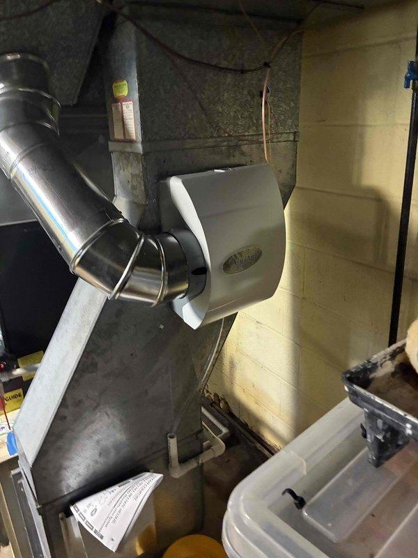 Installed an Aprilaire 600 whole-home bypass humidifier on the supply plenum, connecting the flexible duct bypass with clamped elbow joints and routing the PVC condensate drain and supply water line. Inspected the blower assembly and found dust and grime buildup on the blower wheel blades and hub. Installed an Aprilaire 600 whole-home bypass humidifier on the supply plenum, connecting the flexible duct bypass with clamped elbow joints and routing the PVC condensate drain and supply water line. Inspected the blower assembly and found dust and grime buildup on the blower wheel blades and hub.