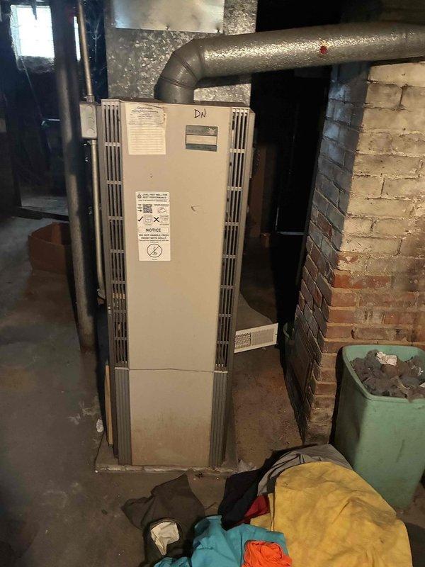 Responded to a no-heat call on a downflow furnace located in an unfinished basement and inspected the unit, its surrounding area, and the thermostat controls. Verified thermostat operation and call-for-heat functionality, then evaluated the furnace's ignition and safety circuits to diagnose the cause of the heating failure. Noted debris and lint accumulation near the unit and recommended clearing the area to maintain proper combustion air and clearances. Responded to a no-heat call on a downflow furnace located in an unfinished basement and inspected the unit, its surrounding area, and the thermostat controls. Verified thermostat operation and call-for-heat functionality, then evaluated the furnace's ignition and safety circuits to diagnose the cause of the heating failure. Noted debris and lint accumulation near the unit and recommended clearing the area to maintain proper combustion air and clearances.