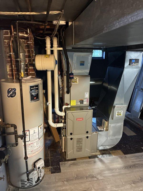 Performed an on-site evaluation for a full HVAC system replacement, inspecting the existing Bryant gas furnace, ductwork transition, thermostat, and adjacent water heater in the basement utility area, with no visible rust, frost, or equipment damage noted. Reviewed the electrical service panel, including the main breaker and the dedicated furnace and air conditioning circuits, to confirm electrical readiness for new equipment. Documented conditions with photos and prepared furnace and complete system replacement options for the customer's consideration. Performed an on-site evaluation for a full HVAC system replacement, inspecting the existing Bryant gas furnace, ductwork transition, thermostat, and adjacent water heater in the basement utility area, with no visible rust, frost, or equipment damage noted. Reviewed the electrical service panel, including the main breaker and the dedicated furnace and air conditioning circuits, to confirm electrical readiness for new equipment. Documented conditions with photos and prepared furnace and complete system replacement options for the customer's consideration.