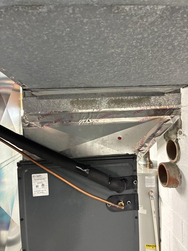Performed an on-site evaluation of the existing furnace and air handler installation to compare repair versus replacement options. Inspected the basement equipment, including the plenum and supply ductwork, refrigerant lines, and condensate piping, and noted the return location and existing system layout. Documented findings with photos, including deteriorated duct insulation and peeling foil tape at the plenum, to support the replacement recommendation. Performed an on-site evaluation of the existing furnace and air handler installation to compare repair versus replacement options. Inspected the basement equipment, including the plenum and supply ductwork, refrigerant lines, and condensate piping, and noted the return location and existing system layout. Documented findings with photos, including deteriorated duct insulation and peeling foil tape at the plenum, to support the replacement recommendation.