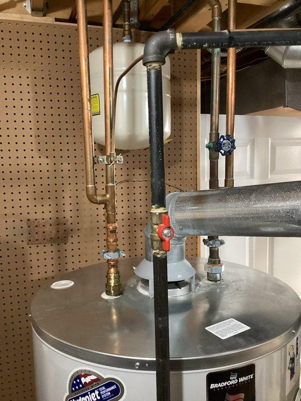 Performed service on a Bradford White gas tank-type water heater, inspecting the supply and outlet copper piping, shutoff valve, thermal expansion tank, gas supply with ball valve, and galvanized flue connection through the draft hood. All connections were found secure with no evidence of leaks, corrosion, or venting issues, and the unit was verified operational. Performed service on a Bradford White gas tank-type water heater, inspecting the supply and outlet copper piping, shutoff valve, thermal expansion tank, gas supply with ball valve, and galvanized flue connection through the draft hood. All connections were found secure with no evidence of leaks, corrosion, or venting issues, and the unit was verified operational.