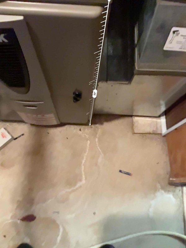 Performed an on-site evaluation for replacement of an existing forced-air HVAC system, inspecting the furnace/air handler cabinet, supply plenum and ductwork, condensate drain piping, and installation area. Documented existing conditions, including cabinet and duct wear, efflorescence and staining on the concrete slab indicating prior moisture exposure, and unit clearance measurements (approximately 33 inches) to determine sizing and installation requirements. Reviewed AC replacement options for the customer and noted site conditions to be addressed prior to installation. Performed an on-site evaluation for replacement of an existing forced-air HVAC system, inspecting the furnace/air handler cabinet, supply plenum and ductwork, condensate drain piping, and installation area. Documented existing conditions, including cabinet and duct wear, efflorescence and staining on the concrete slab indicating prior moisture exposure, and unit clearance measurements (approximately 33 inches) to determine sizing and installation requirements. Reviewed AC replacement options for the customer and noted site conditions to be addressed prior to installation.