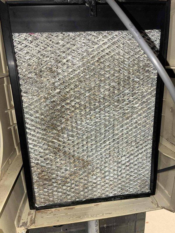 Performed a heating-season tune-up, including a borescope inspection of the heat exchanger cavity that revealed surface rust and accumulated debris on the fins and surrounding surfaces. Inspected the humidifier evaporator pad and found heavy mineral scale buildup and rust staining, indicating the pad is due for cleaning or replacement. Performed a heating-season tune-up, including a borescope inspection of the heat exchanger cavity that revealed surface rust and accumulated debris on the fins and surrounding surfaces. Inspected the humidifier evaporator pad and found heavy mineral scale buildup and rust staining, indicating the pad is due for cleaning or replacement.
