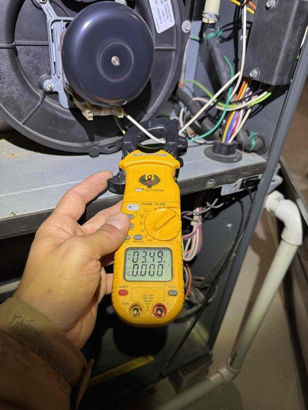 Aurora, OH - Responded to a no-heat call and performed electrical diagnostics on the furnace using a digital clamp meter to measure amperage draw on the motor circuit wiring within the blower compartment. Inspected the cabinet interior, including the inducer/blower assembly, control wiring, and condensate PVC piping, to isolate the cause of the heat failure. Aurora, OH - Responded to a no-heat call and performed electrical diagnostics on the furnace using a digital clamp meter to measure amperage draw on the motor circuit wiring within the blower compartment. Inspected the cabinet interior, including the inducer/blower assembly, control wiring, and condensate PVC piping, to isolate the cause of the heat failure.