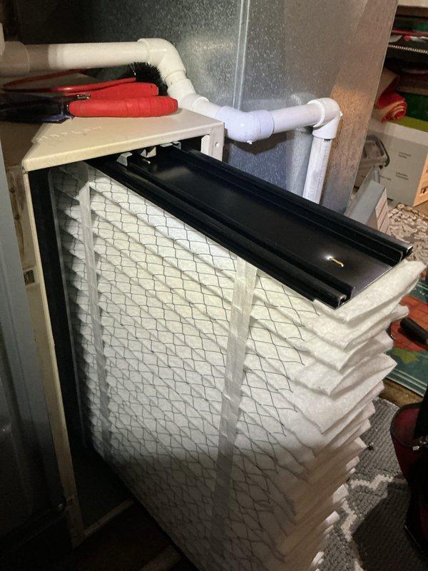 Performed a seasonal heating tune-up, inspecting the furnace cabinet, ductwork, and filter housing. Removed and inspected the pleated air filter, which showed discoloration and debris loading along the pleats, and recommended replacement to maintain proper airflow and system efficiency. Noted moisture staining on the floor near the adjacent water heater and condensate piping, and advised monitoring the area for a possible leak. Performed a seasonal heating tune-up, inspecting the furnace cabinet, ductwork, and filter housing. Removed and inspected the pleated air filter, which showed discoloration and debris loading along the pleats, and recommended replacement to maintain proper airflow and system efficiency. Noted moisture staining on the floor near the adjacent water heater and condensate piping, and advised monitoring the area for a possible leak.