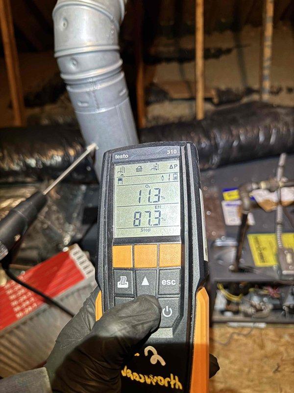 Performed scheduled heating maintenance on an attic-installed Goodman gas furnace, inspecting the cabinet, flue venting, supply plenum, flexible ductwork, and gas connections for proper installation and safe operation. Conducted a combustion analysis with a Testo 310 analyzer, recording 11.3% Oâ‚‚ and 87.3% efficiency, and verified the system was operating within normal parameters, with a replacement pleated air filter on site for installation. Performed scheduled heating maintenance on an attic-installed Goodman gas furnace, inspecting the cabinet, flue venting, supply plenum, flexible ductwork, and gas connections for proper installation and safe operation. Conducted a combustion analysis with a Testo 310 analyzer, recording 11.3% Oâ‚‚ and 87.3% efficiency, and verified the system was operating within normal parameters, with a replacement pleated air filter on site for installation.