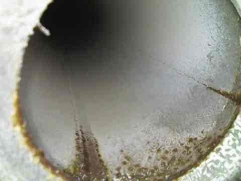 Performed tune-up on a 32-year-old Luxaire furnace, inspecting the heat exchanger, flue/vent piping, and cabinet interior. Observed rust-colored corrosion and staining along the flue pipe interior with a seam crack showing rust discoloration, along with minor surface pitting and seam staining on the heat exchanger tubes. Given the unit's age and the corrosion found, recommend further evaluation of heat exchanger and venting integrity and consideration of system replacement. Performed tune-up on a 32-year-old Luxaire furnace, inspecting the heat exchanger, flue/vent piping, and cabinet interior. Observed rust-colored corrosion and staining along the flue pipe interior with a seam crack showing rust discoloration, along with minor surface pitting and seam staining on the heat exchanger tubes. Given the unit's age and the corrosion found, recommend further evaluation of heat exchanger and venting integrity and consideration of system replacement.