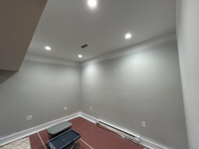 Electrical rough-in throughout the basement, 4” can lights in main room and office, bath fan and GFCI in bathroom, and smoke detector installed.