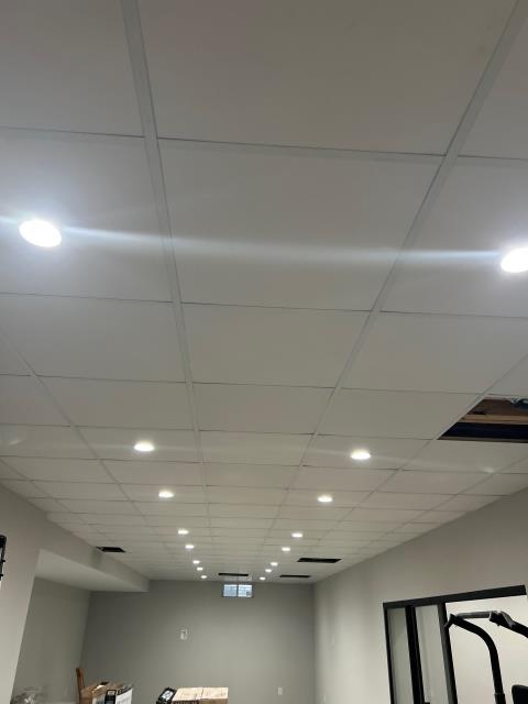 Electrical rough-in throughout the basement, 4” can lights in main room and office, bath fan and GFCI in bathroom, and smoke detector installed.