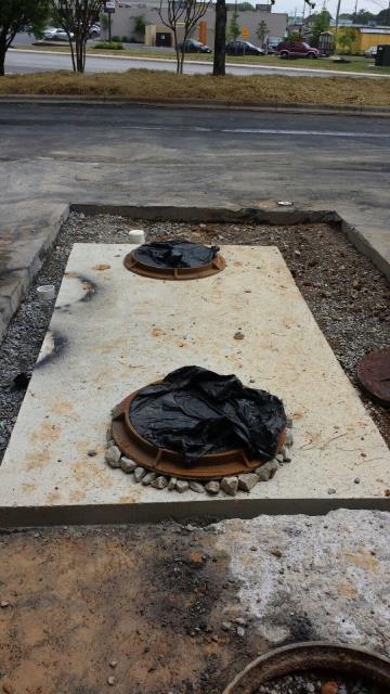 Pumped old grease interceptor and filled in. Installed 1500 Gallon Grease Trap.  Rerouted plumbing and drains. Repoured concrete
