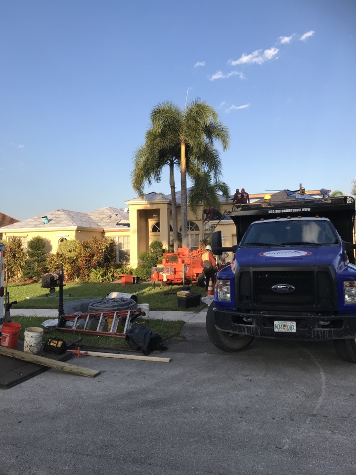 Checking on a re-roof and Davie roof tiles being removed roof tiles going back installing tag and stickers and underlayment Checking on a re-roof and Davie roof tiles being removed roof tiles going back installing tag and stickers and underlayment