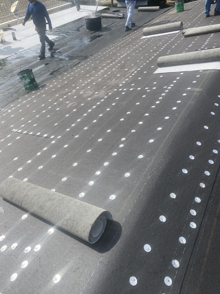 West Park, FL - Inspecting a GAF mineral surface fiberglass cap sheet in West Park West Park, FL - Inspecting a GAF mineral surface fiberglass cap sheet in West Park