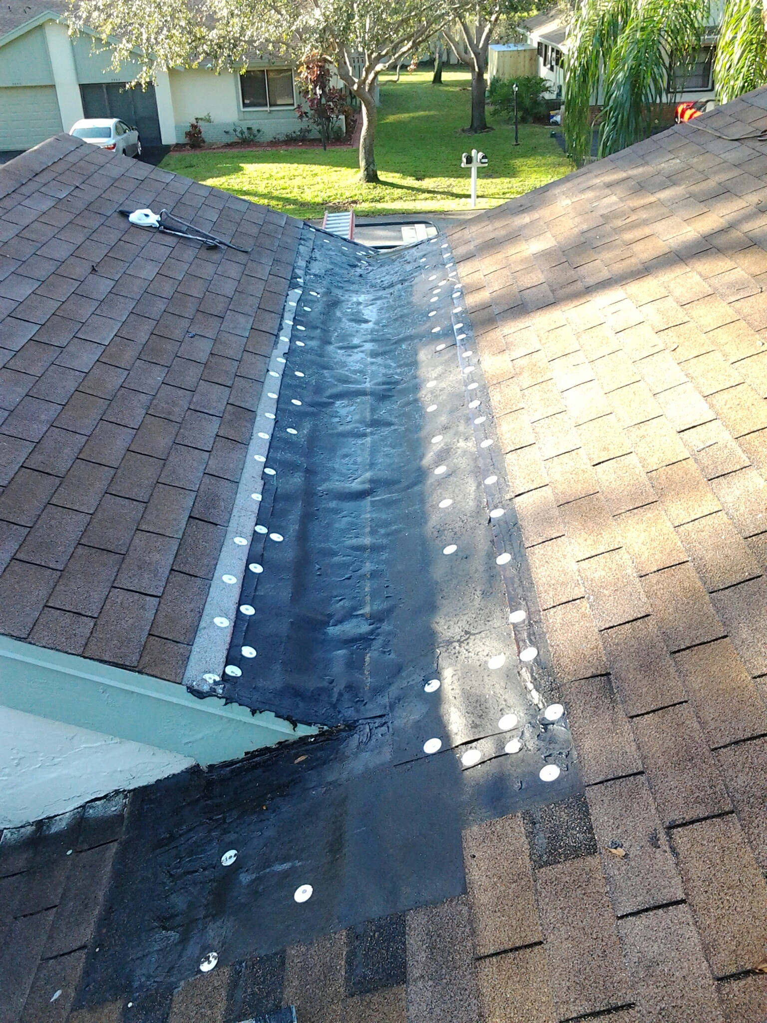 Delray Beach, FL - Mike and Earl Johnston roofing ready to install new metal in cricket. Delray Beach, FL - Mike and Earl Johnston roofing ready to install new metal in cricket.