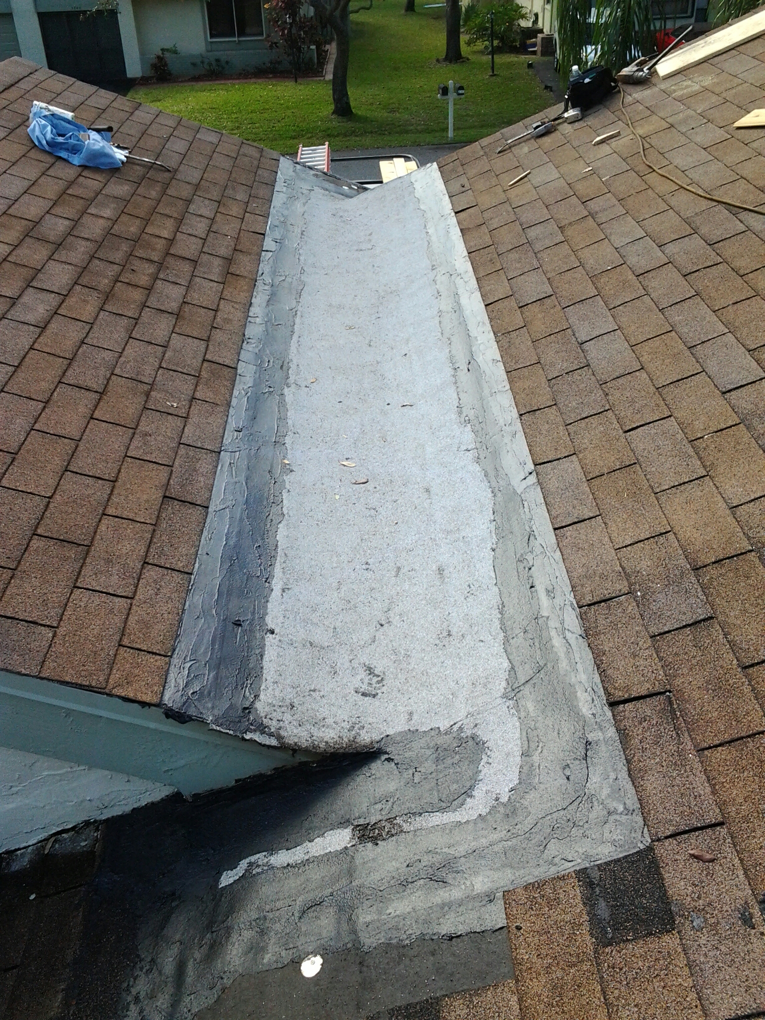 Delray Beach, FL - Mike and Earl Johnston roofing ready to install new shingles in cricket area Delray Beach, FL - Mike and Earl Johnston roofing ready to install new shingles in cricket area