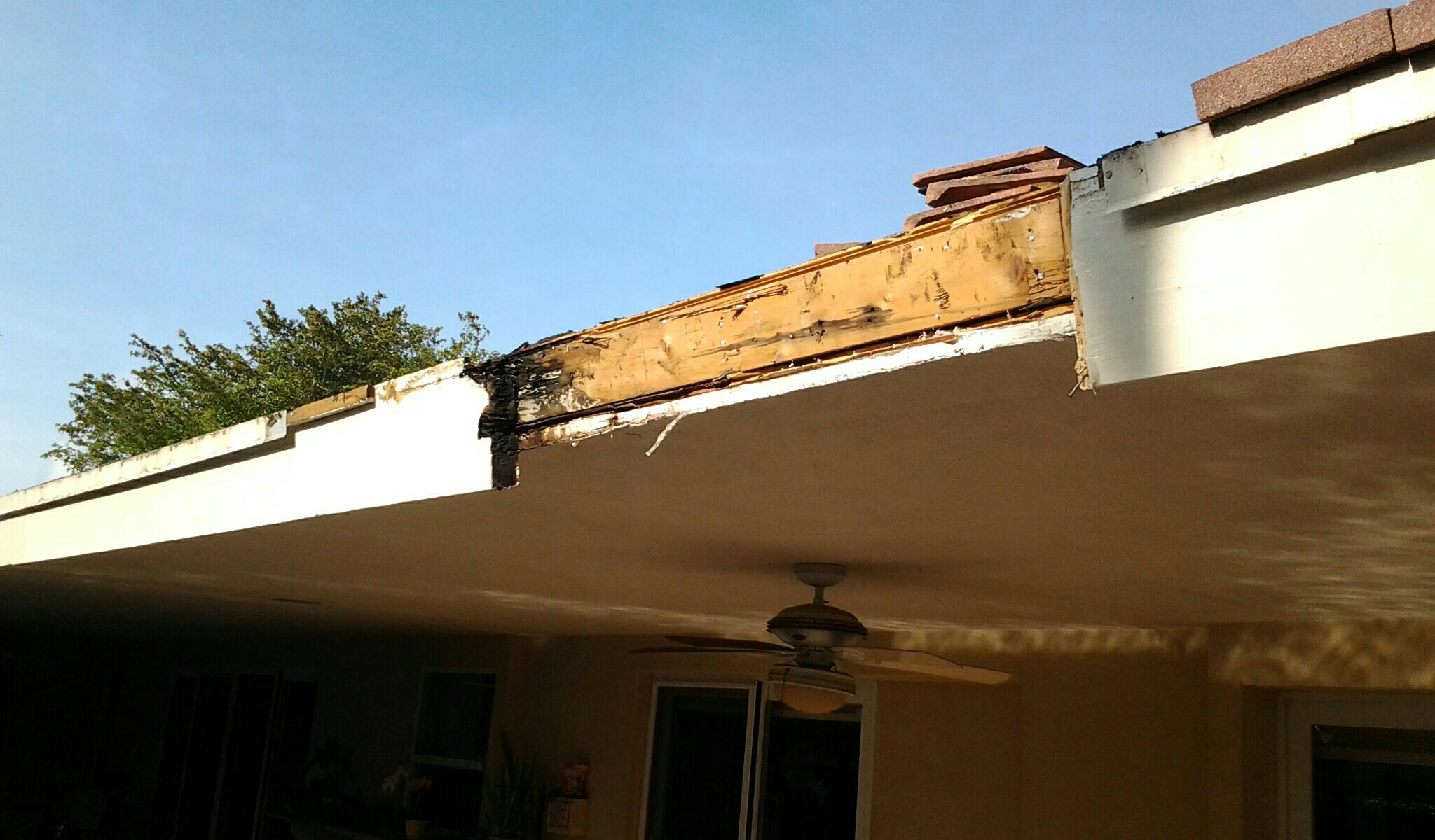Pinecrest, FL - Mike and Earl Johnston roofing doing a tile repair with rotten fascia board. Pinecrest, FL - Mike and Earl Johnston roofing doing a tile repair with rotten fascia board.