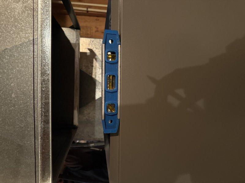 Completed full system installation including EL297V 90k furnace, EL15KC1 3-ton condenser, cased coil (3-ton C frame), and new media cabinet. Installed 18ft of 3" PVC venting, replaced rusted 14x10 duct on front of plenum, relocated 6" run from top of plenum, and cut back leaking 3" PVC exhaust. Verified proper leveling of equipment during installation.