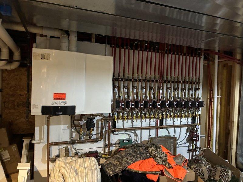 Responded to service call for a Buderus GB142 boiler with 6A error code in detached garage. Discovered wasp nest inside PVC venting which was causing system failure; removed nest and restored operation. Also inspected residential multi-zone boiler system with 11 zones to gather information for future maintenance requirements.