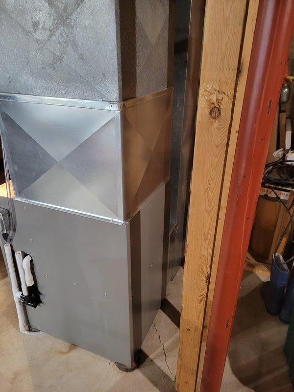 Successfully completed installation of Lennox EL297E 90K furnace with built-in K-furnace sensor. Properly mounted unit on platform, connected intake/exhaust PVC venting, and integrated with existing ductwork system and thermostat. System is now operational with proper connections to all necessary infrastructure.