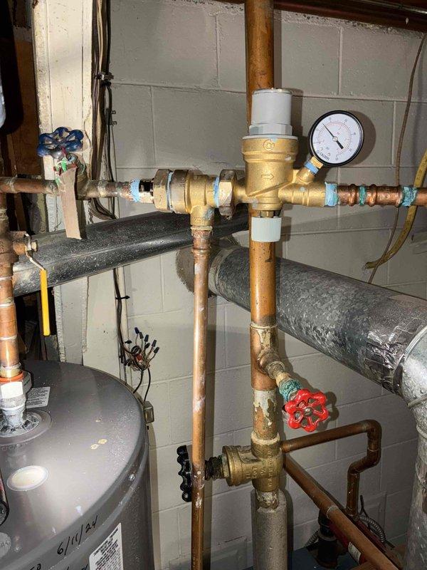 Responded to a callback regarding persistent leakage from boiler system after previous service. Inspection revealed shredded gasket inside backflow preventer/pressure reducing valve combo unit. Replaced damaged gasket, resealed system, and restored proper pressure. System successfully tested through two complete heating cycles with no active leaks detected.