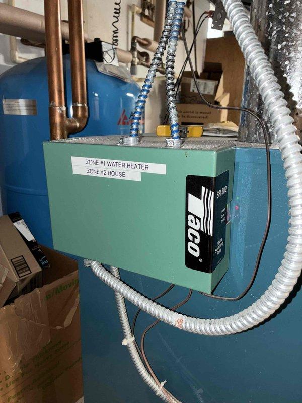 Diagnosed and resolved noisy radiator issue on 2nd floor caused by trapped air in cast iron radiators. Performed comprehensive air bleeding of all radiators on both main and 2nd floors, then recirculated water through the system and re-bled 2nd floor radiators as needed. Verified proper operation of pressure reducing valve auto-fill function and confirmed all radiators were heating properly.