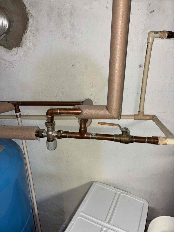 Diagnosed and resolved noisy radiator issue on 2nd floor caused by trapped air in cast iron radiators. Performed comprehensive air bleeding of all radiators on both main and 2nd floors, then recirculated water through the system and re-bled 2nd floor radiators as needed. Verified proper operation of pressure reducing valve auto-fill function and confirmed all radiators were heating properly.