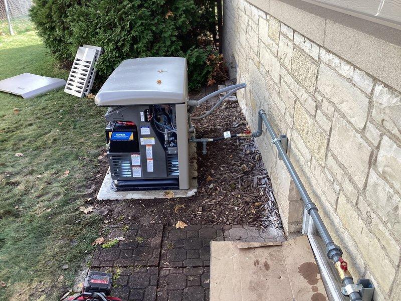 Successfully installed a 20KW Kohler air-cooled home standby generator with aluminum cabinet on a concrete pad alongside customer's residence. Installed 100A service-rated Automatic Transfer Switch adjacent to the electrical panel in the basement, including all necessary low and line voltage wiring. Completed proper grounding and bonding, and installed all required gas piping with exterior lines painted gray using oil-based paint as specified.