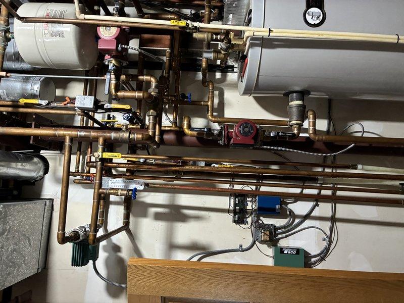 Investigated and isolated leak in a combination hot water and heating boiler system. Inspected the HTP unit, expansion tanks, and complex copper piping network to identify areas of concern. Added isolation valves to strategically separate sections, enabling partial system operation while containing the leak area for future repair in spring.