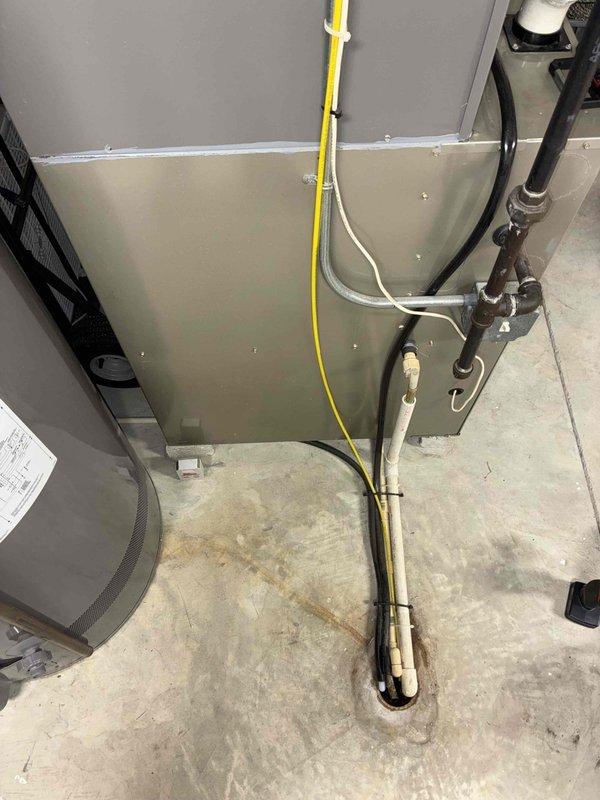 Responded to a service call for a non-functional Lennox humidifier at a new customer residence. During inspection, observed the complete HVAC system which included a beige furnace/air handler unit with a TRION "Air Bear" media air cleaner. System also featured proper drainage with PVC pipes and appropriate copper line connections. Diagnosed humidifier issue and restored functionality to improve indoor air quality.
