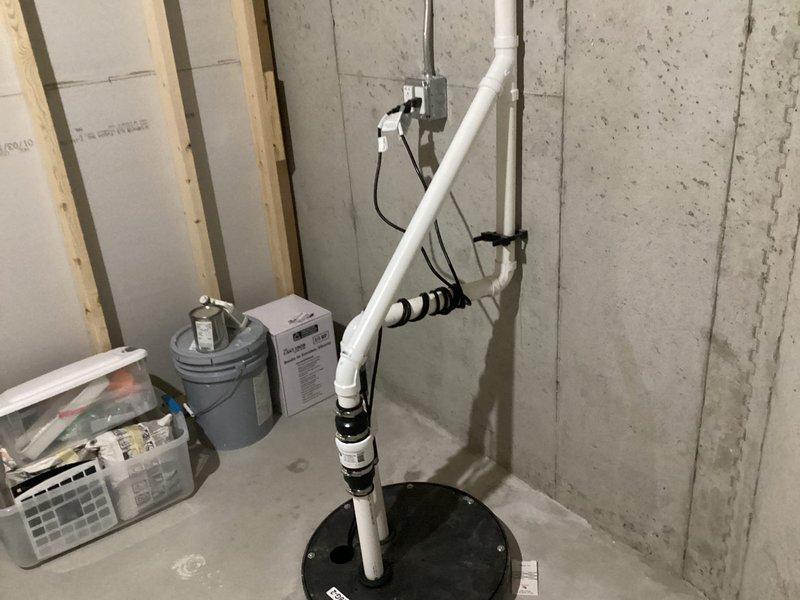 Installed secondary sump pump system in basement with proper PVC piping configuration and check valve to provide backup water management protection. System was successfully connected to existing electrical supply and tested to ensure proper operation.