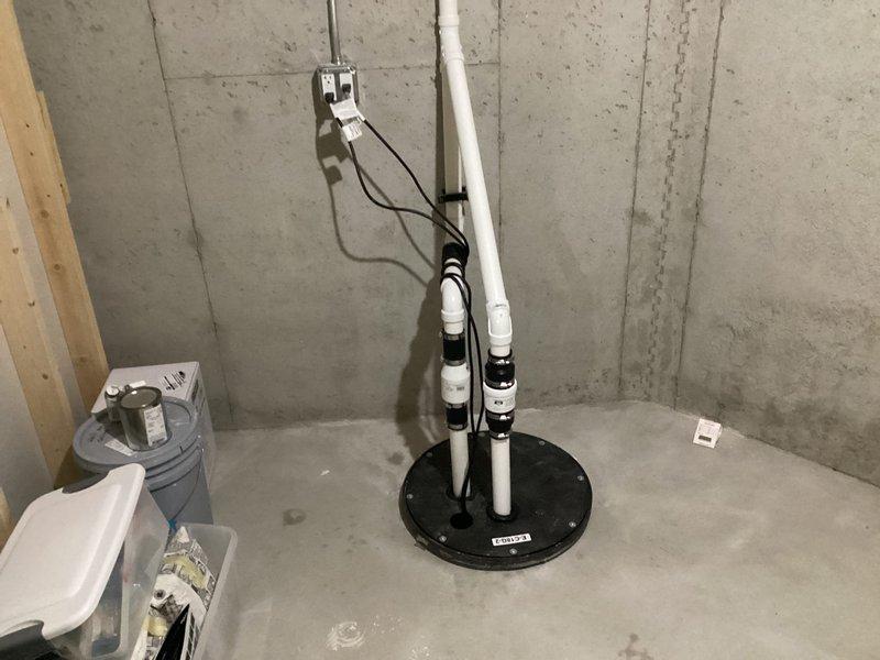 Installed secondary sump pump system in basement with proper PVC piping configuration and check valve to provide backup water management protection. System was successfully connected to existing electrical supply and tested to ensure proper operation.