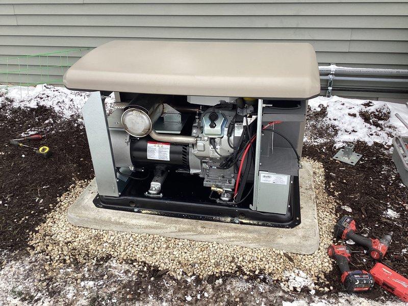 Successfully installed a 20KW Kohler Air-cooled Home Standby Generator (model 20RCA) with aluminum cabinet and 200AMP service-rated automatic transfer switch for whole-house backup power. Set generator on prepared concrete pad with gravel surround after ground thawing, completed all necessary low/line voltage wiring, and installed gas pipe with connections and exterior gray oil-based paint finish. System includes battery, carburetor heater, and oil heater with proper grounding and bonding.