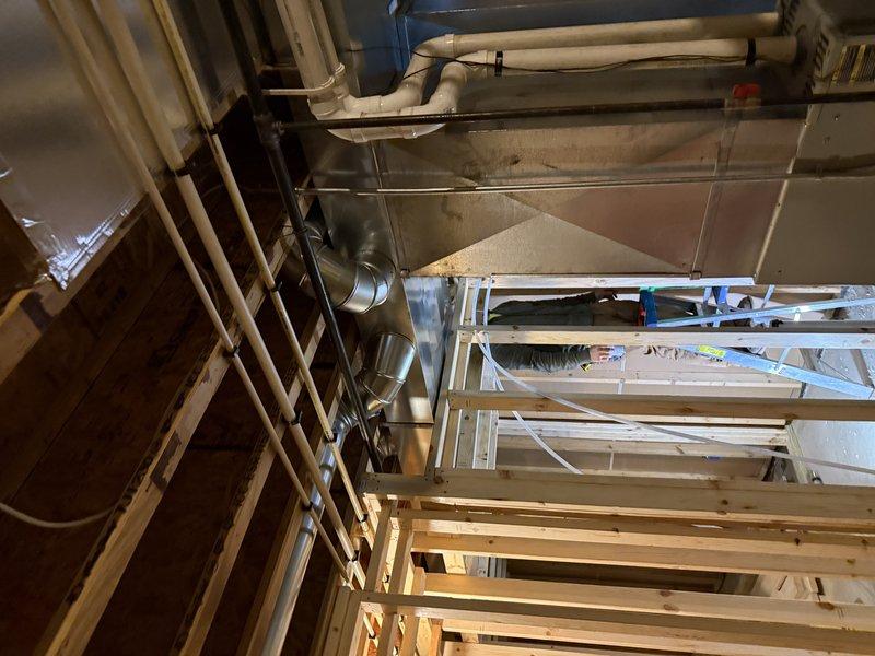 Completed installation of 5 new supply runs to basement area with two registers per bedroom and one in open area. Installed 2 low return grilles (one per bedroom) and vented existing exhaust fan. All ductwork was properly connected to existing HVAC system with metal components secured through exposed framing, and exterior ventilation was completed with proper wall penetration and vent cover installation.