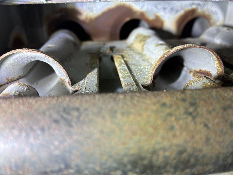 Responded to no heat call on aging system (10+ years). Inspection revealed severely corroded heat exchanger with significant rust buildup and mineral deposits on burner components. Performed comprehensive cleaning of system components as sold by Dave under CCC service. Unit successfully restored to proper heating operation.