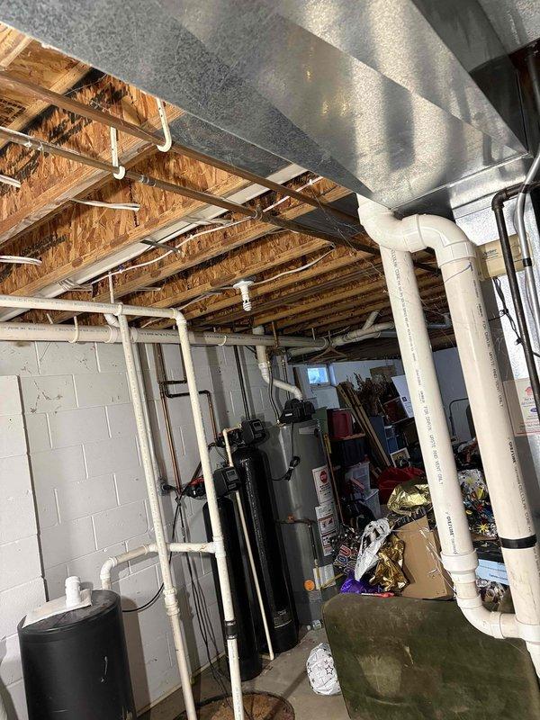 Responded to a no-heat call for a residence with a 10+ year old heating system. Diagnostic inspection revealed a failed heat exchanger, rendering the furnace unsafe for operation. Provided customer with replacement options and quotes for a new furnace system. Photos documented the current installation environment including basement mechanical space and snow-covered outdoor condensing unit.