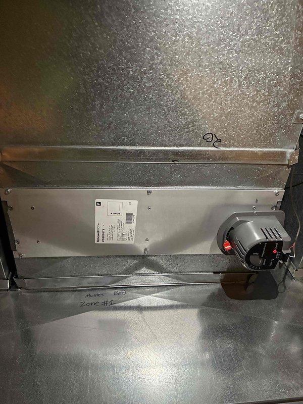 Completed first floor zoning system upgrade with installation of 3 Ecobee smart thermostats, 4 zone dampers (with visible actuator mechanisms for zones #1 and #2), and a zone panel kit. System will provide improved temperature control and efficiency through independent regulation of different areas.