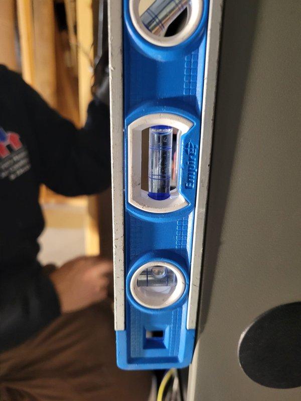 Completed full system installation including SLP99 90K furnace, ML13KC1 3.5-ton condensing unit, 48C-71 cased coil, and S40 thermostat. Installed new 25-foot lineset, reused existing AC brackets and media filter. Executed back-venting with 32 feet of 2" PVC including five 90° elbows. Verified proper system leveling and confirmed thermostat functionality with temperature set to 70°.