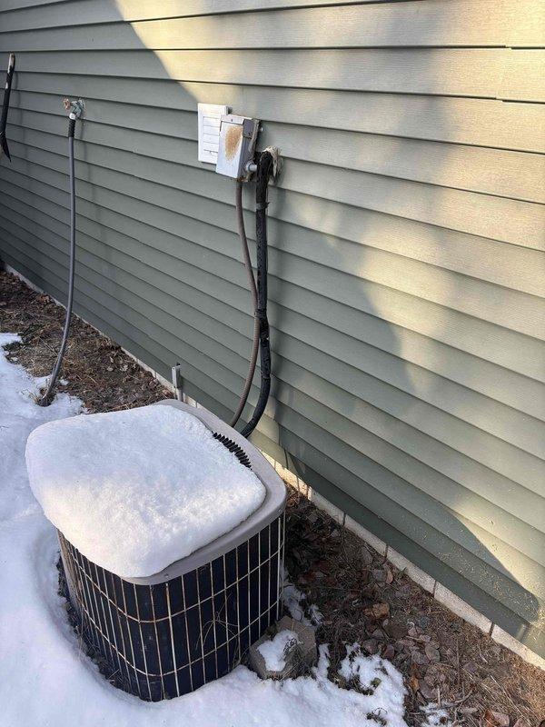 Responded to no heat complaint on residence with dual furnace system. Performed diagnostic inspection on Lennox G1403-40-20 direct vent central furnace showing signs of age. Exterior inspection revealed heat pump/AC unit covered with snow which was cleared to ensure proper airflow and operation.