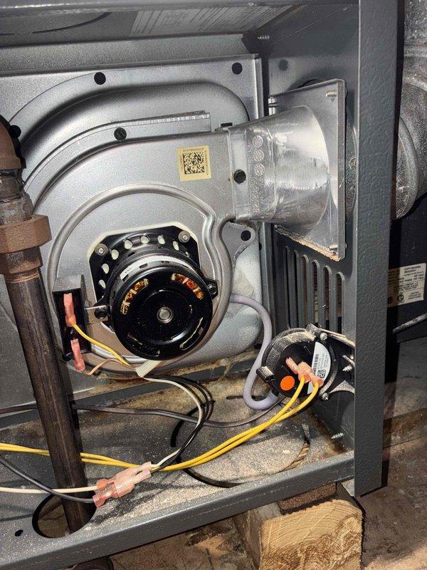 Diagnosed and serviced a Goodman attic furnace mounted horizontally that was non-operational. After inspection of internal components including blower motor assembly, electrical connections, and pressure switch, restored heating functionality. System is aging (10+ years) but now operating within specifications following necessary repairs.