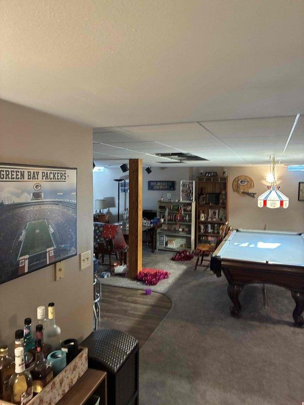 Inspected basement HVAC system for reported leak affecting ceiling tiles. Examined copper refrigerant lines and ductwork for condensation issues. Found inadequately insulated PVC condensate drain line as source of moisture problem. Applied proper insulation to prevent future condensation and protect finished basement recreation area.