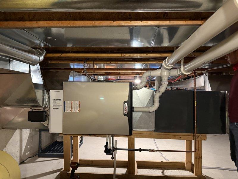 Successfully installed Lennox SLP99 135K BTU high-efficiency furnace in crawl space with new zoning system and wireless thermostats. Reused existing media filter and return, while replacing the cellular core PVC back venting (3" diameter, 22 ft). System was fully tested and verified operational with proper electrical connections completed by on-site electrician.